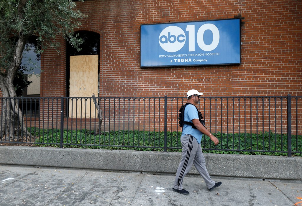 Man walks past window stuck during investigation