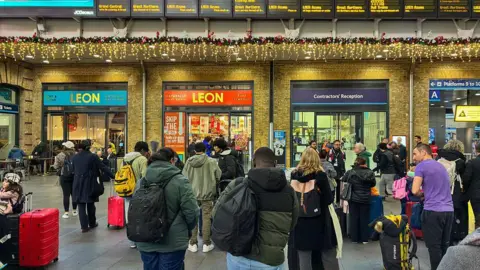 Rail passengers at a major UK station during Christmas period