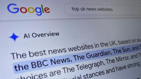 A newsroom with computers and newspapers