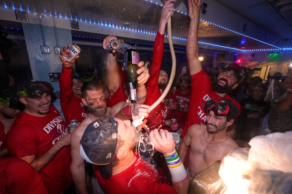 Phillies teammates celebrate after clinching NL East