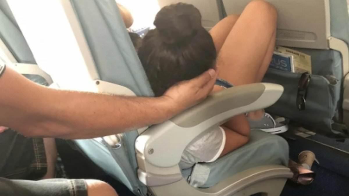Father's gesture to help teenage daughter sleep on plane sparks online debate