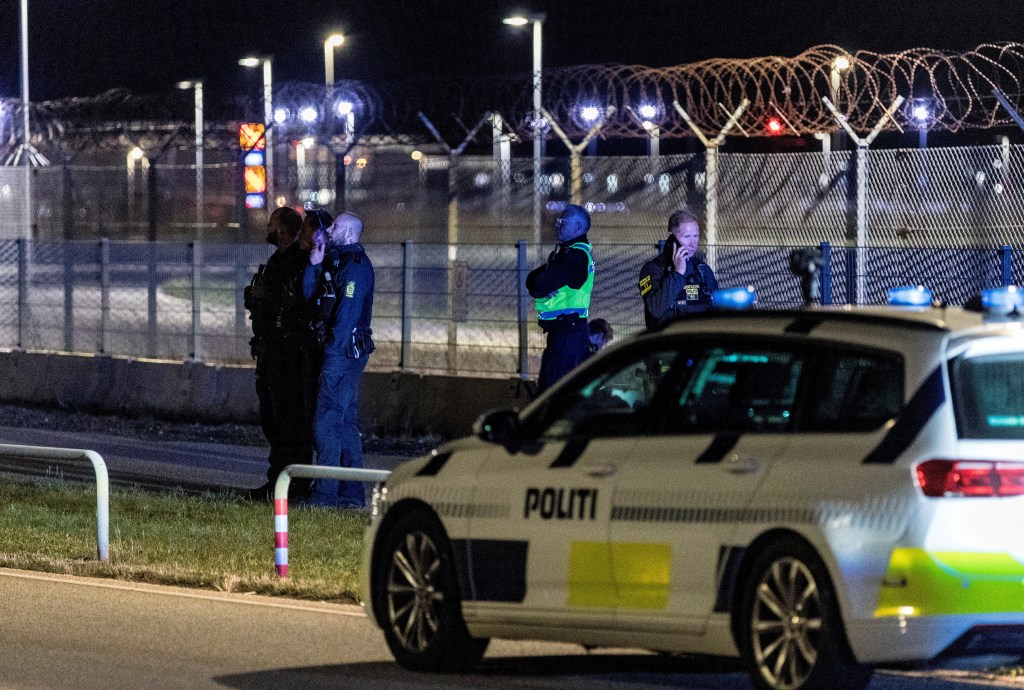 Police officers stand guard after traffic was closed at Copenhagen Airport
