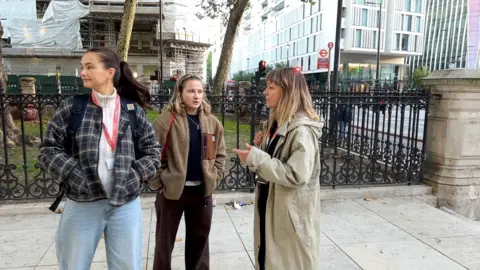 A young woman outside a shop during outreach