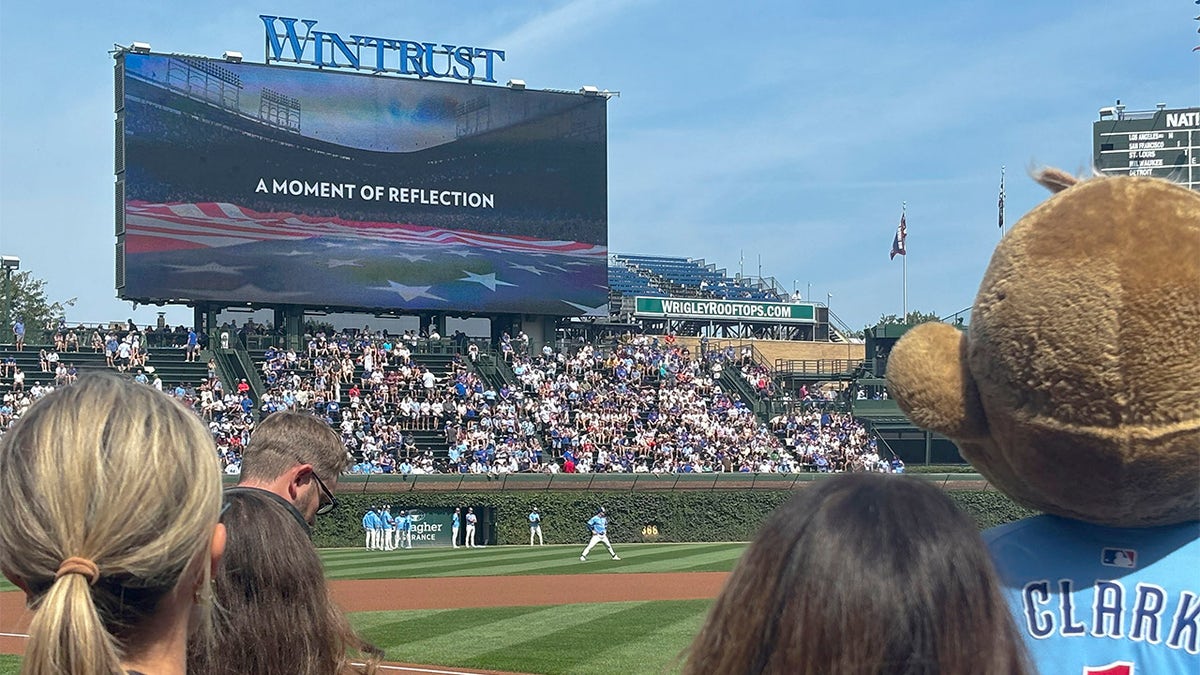 Fans observe a moment of reflection at Wrigley Field