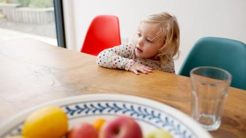 child helping in the kitchen