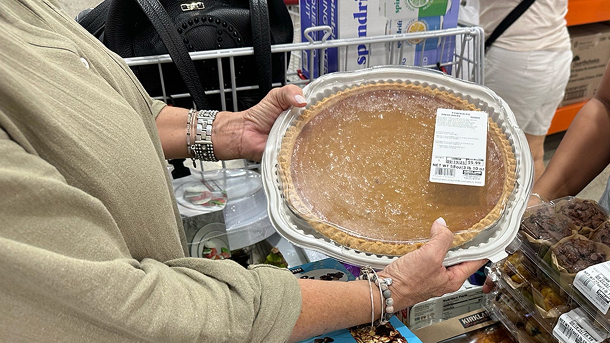 Giant pumpkin pie being held at Costco