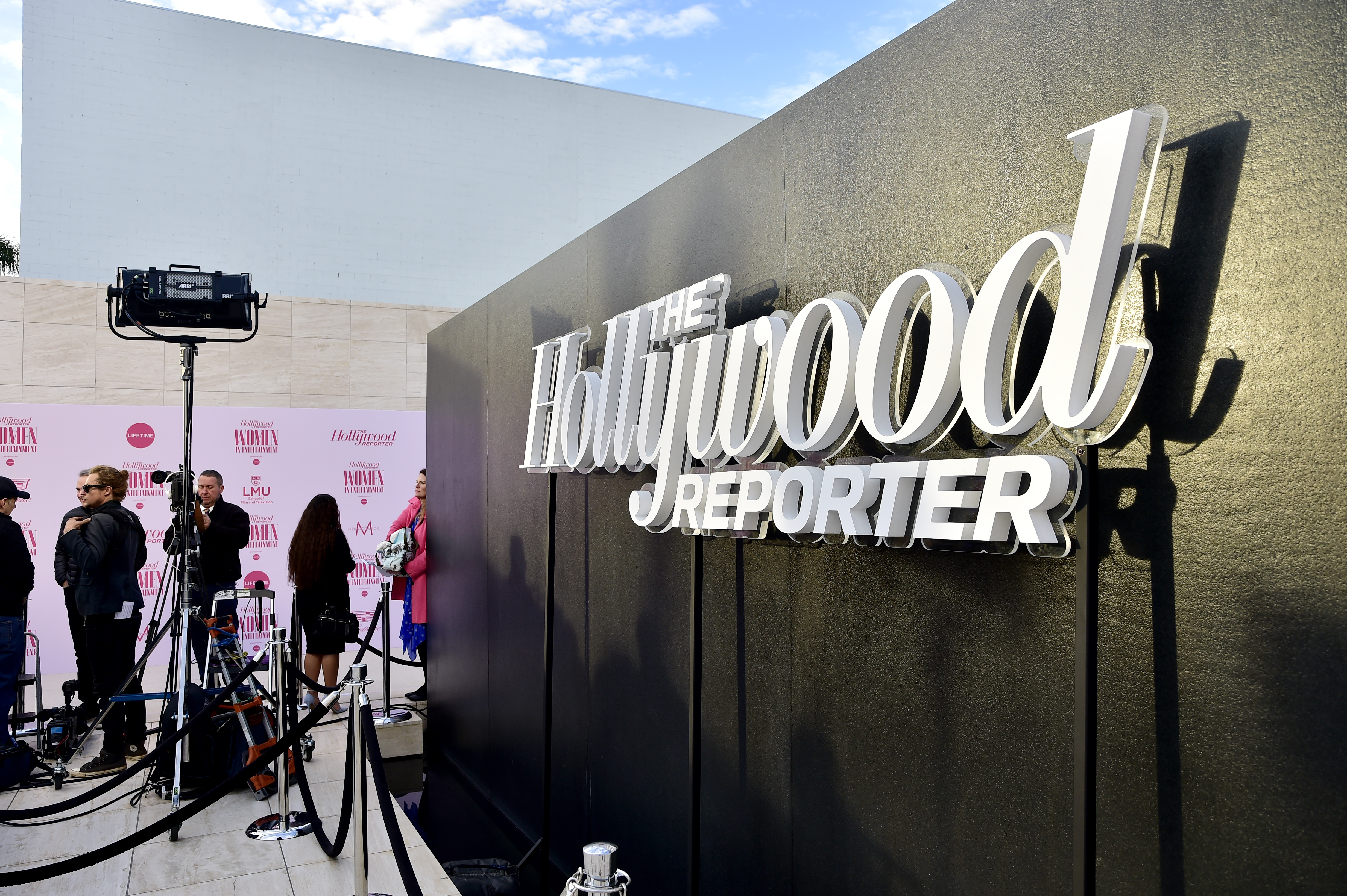 Close-up of a person holding a phone displaying news content