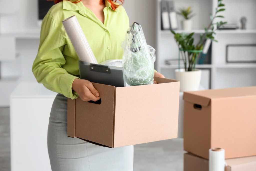 Young business professional packing a box