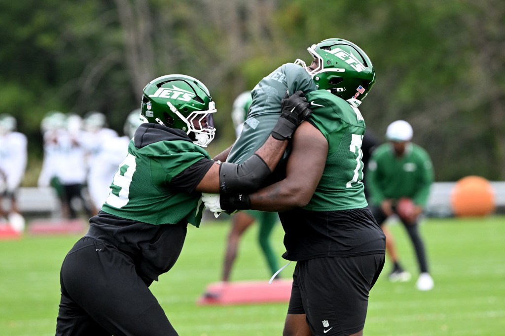 Jets offensive tackles run a drill at practice in Florham Park