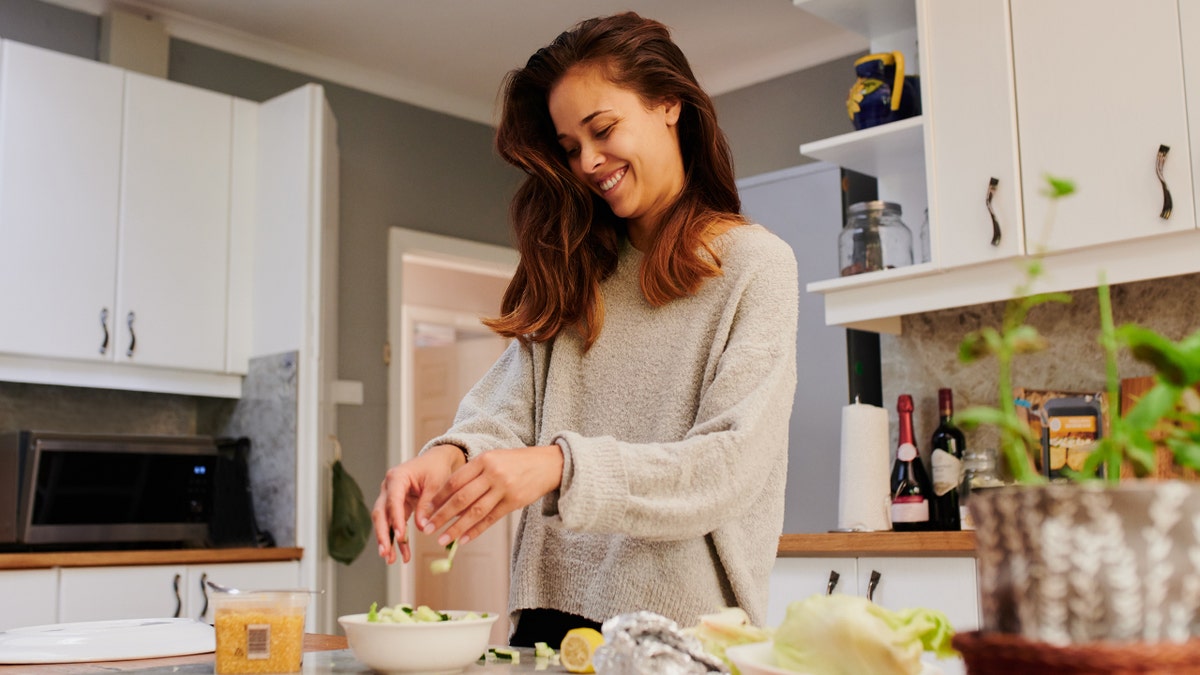 Woman cooking keto happy