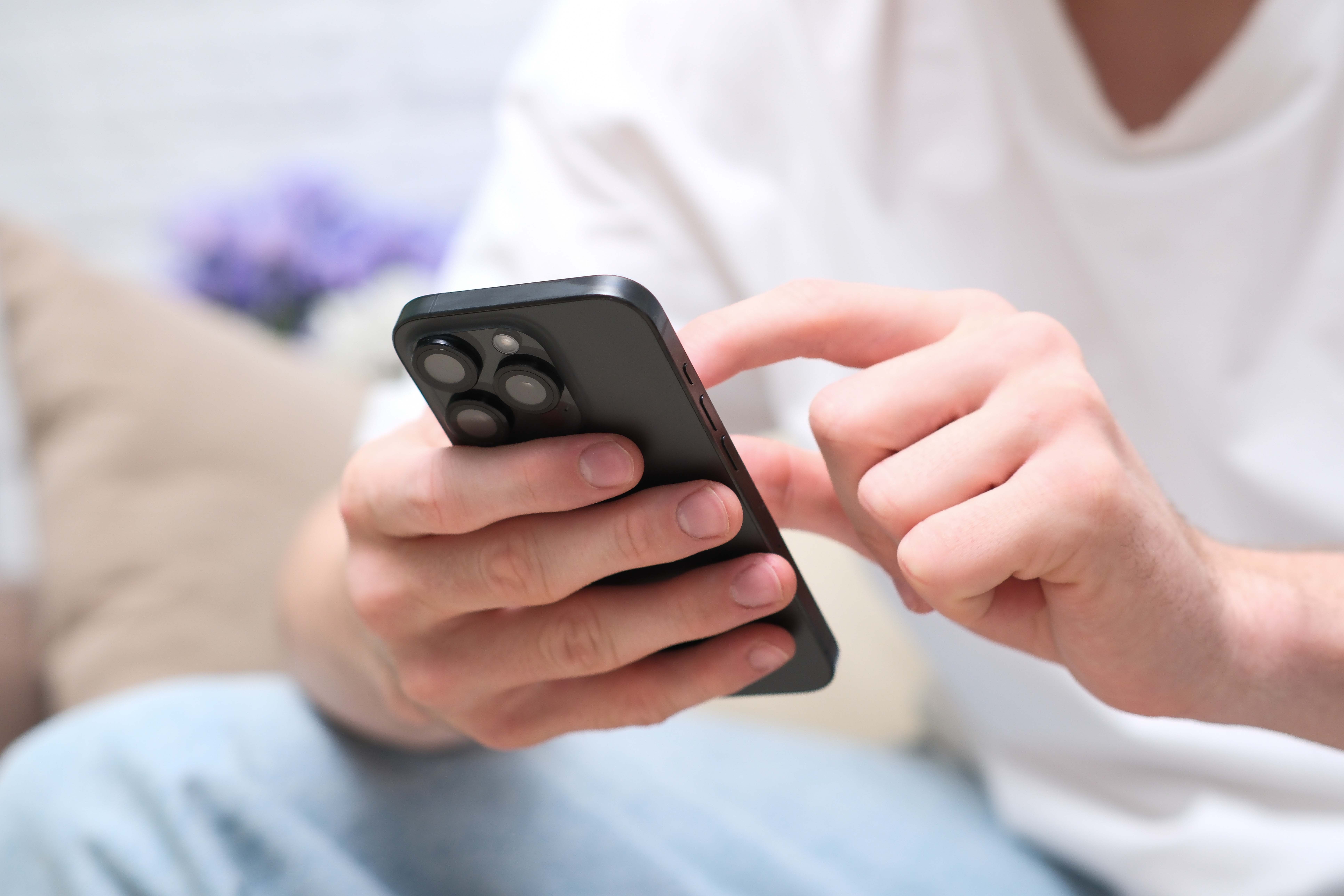 Young man touching smartphone screen