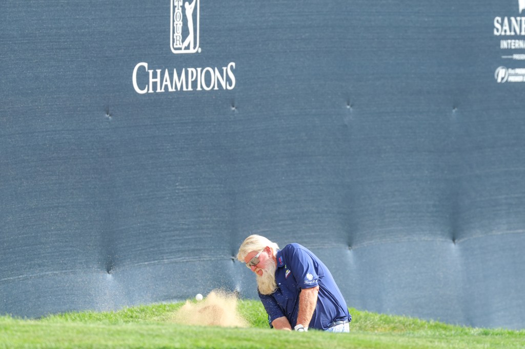 Daly hits from a bunker on the 18th during the first round
