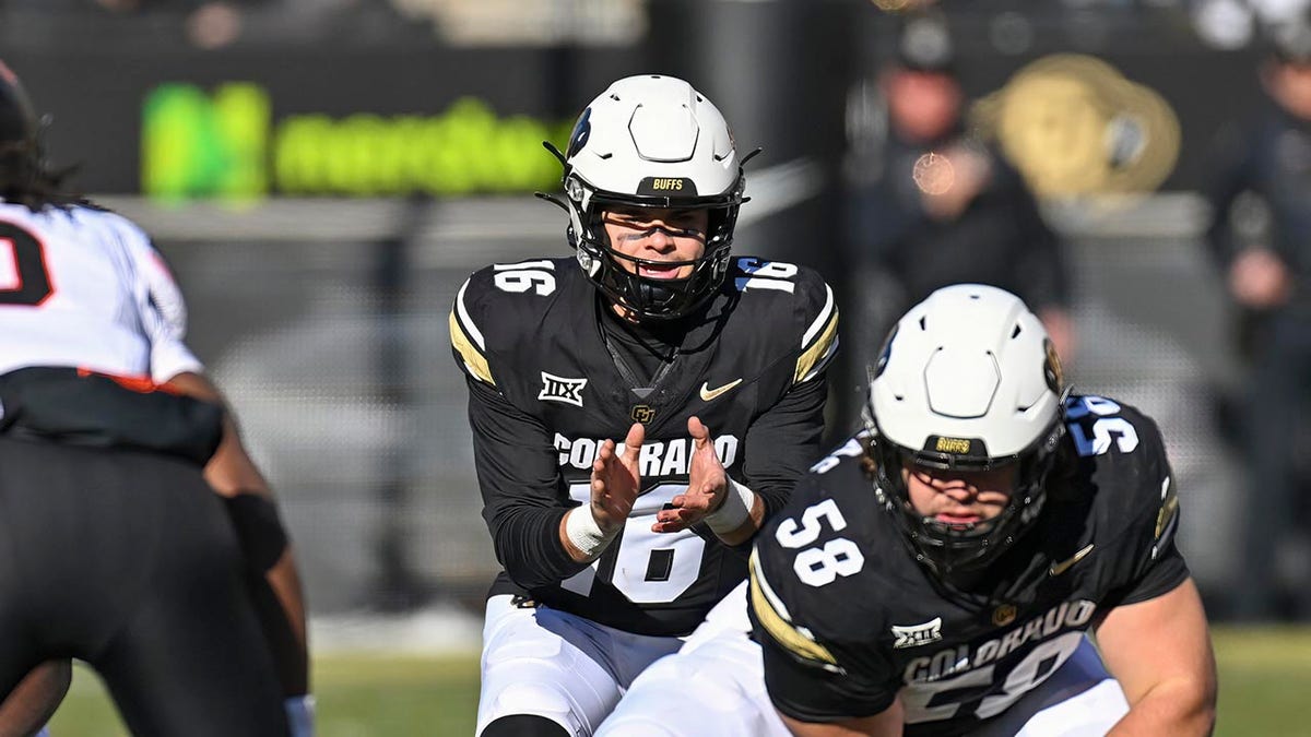 Ryan Staub takes the snap during a college football game