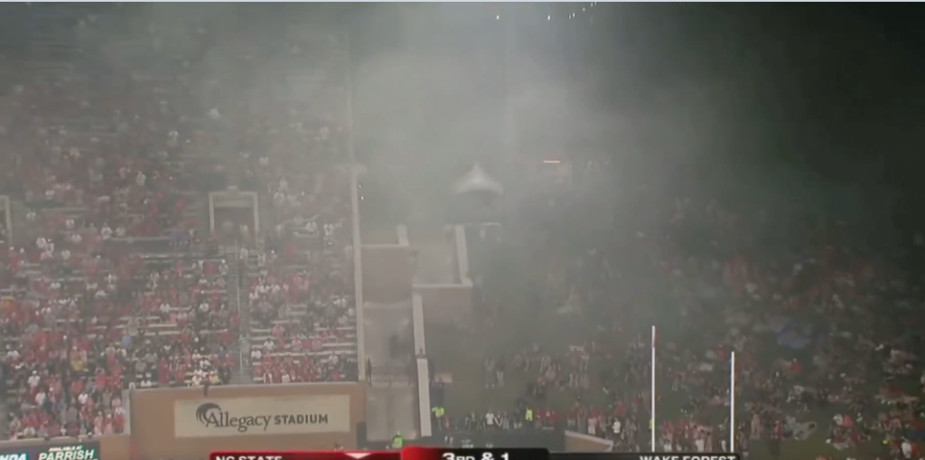 Television screenshot of smoke and fire near the stadium
