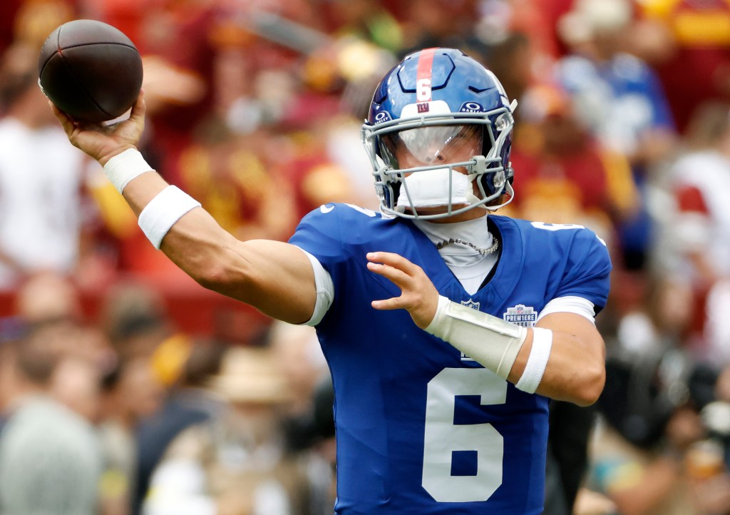 Jaxson Dart throws during warmups