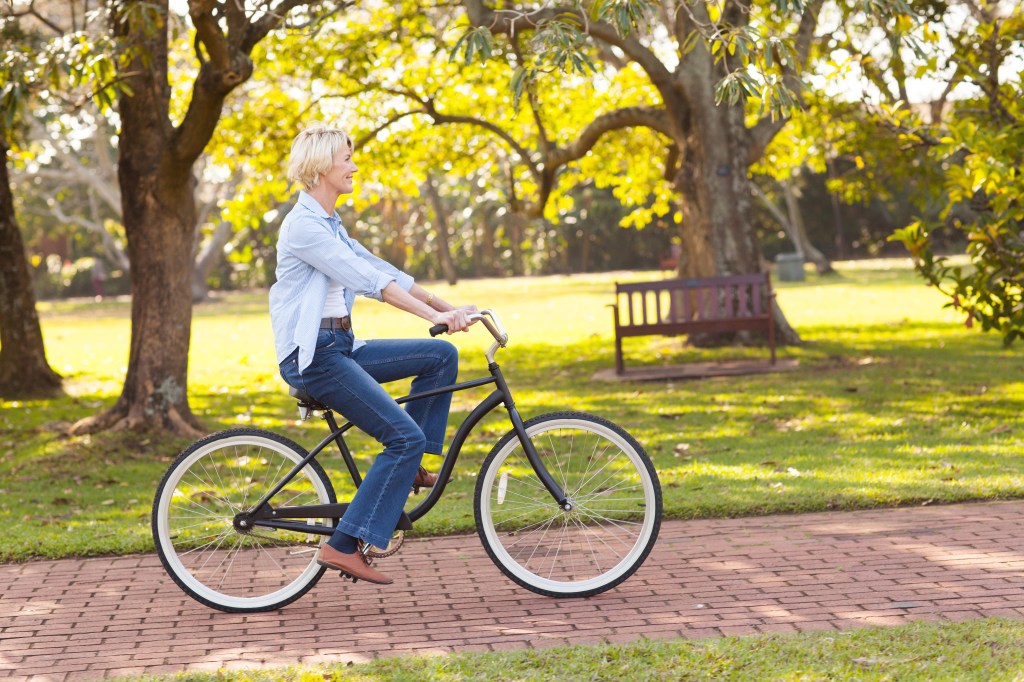 Beautiful mature woman riding bike