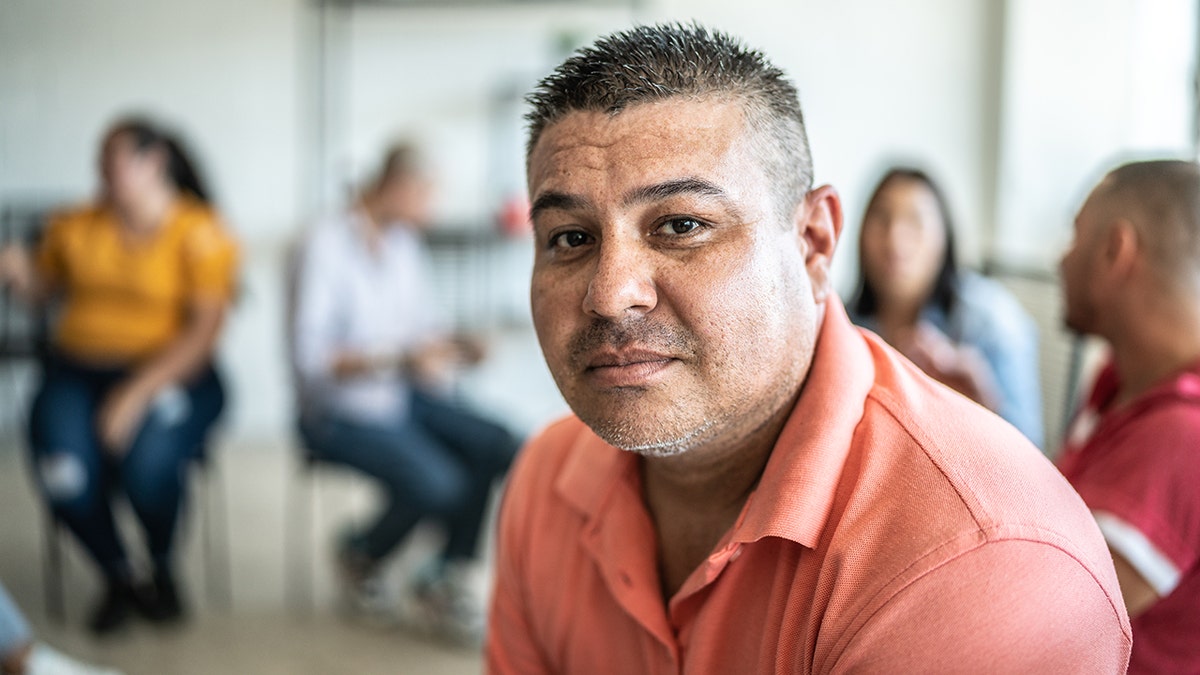 Man in a withdrawn conversation