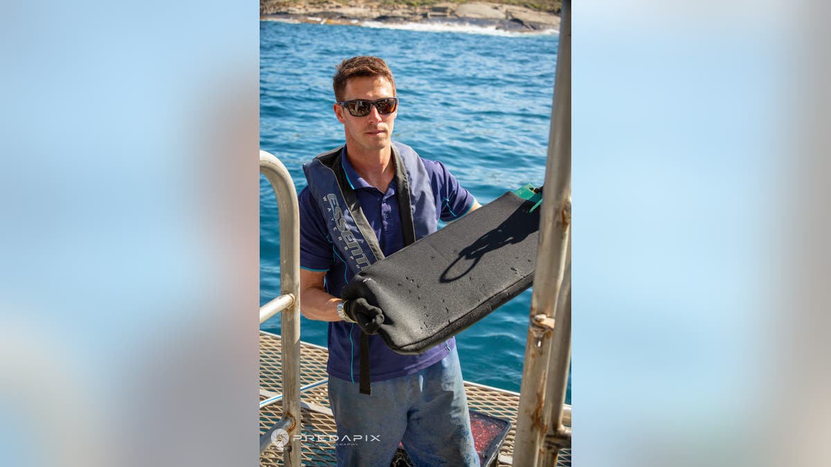Scientist holding wetsuit material