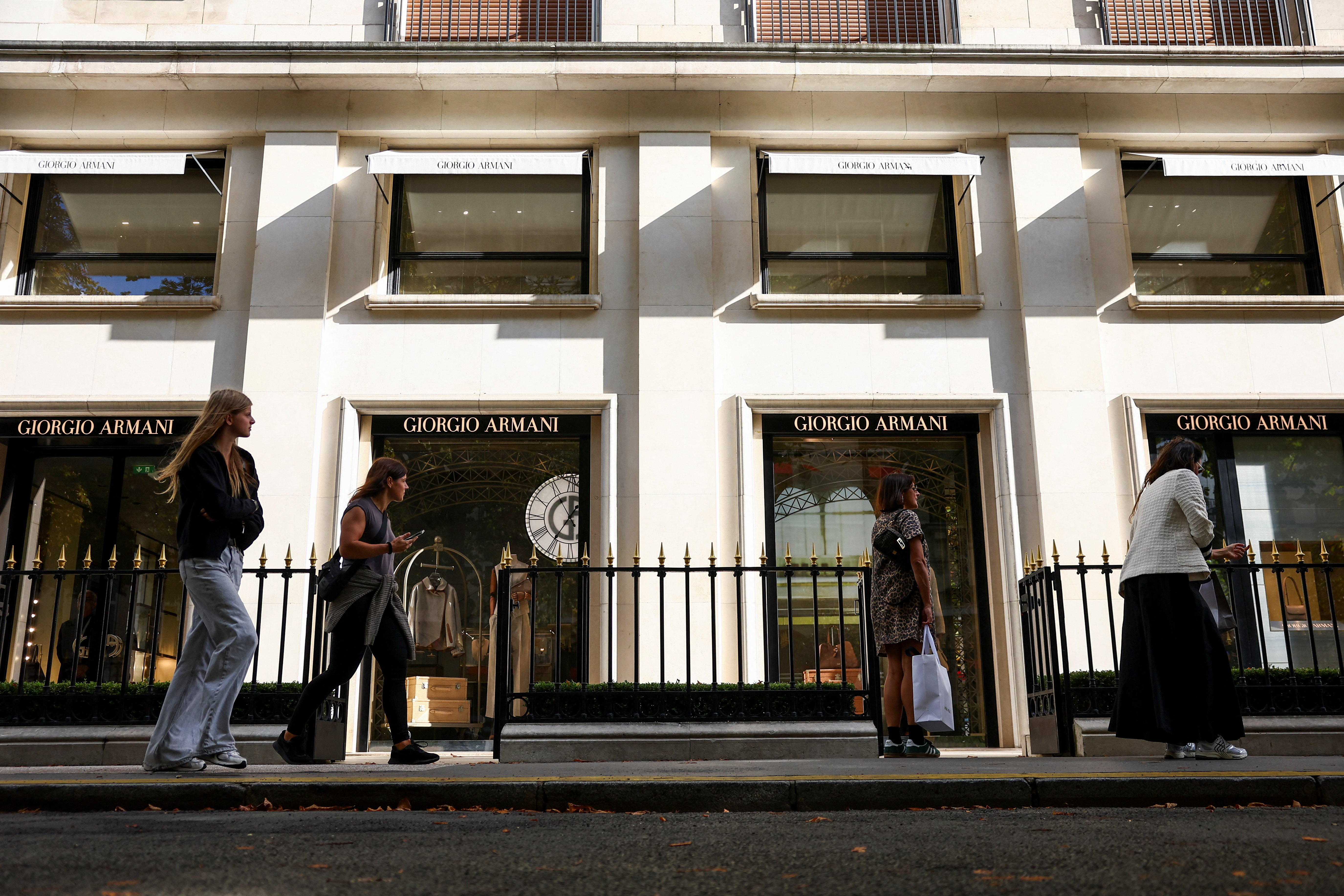 People walk past Giorgio Armani store in Paris after designer's death