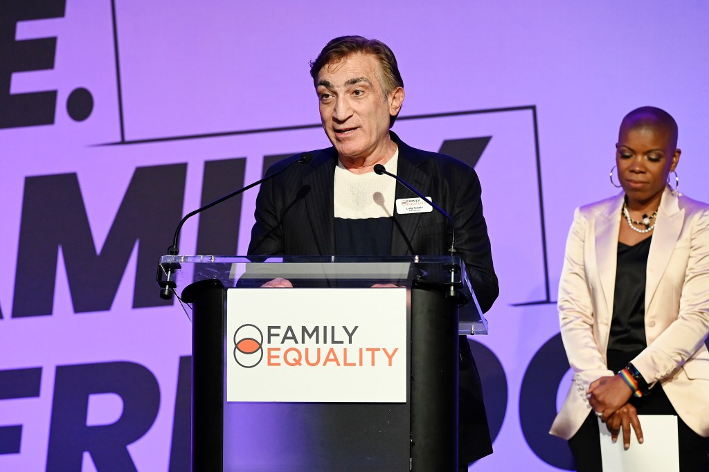 Luigi Caiola speaks onstage with family