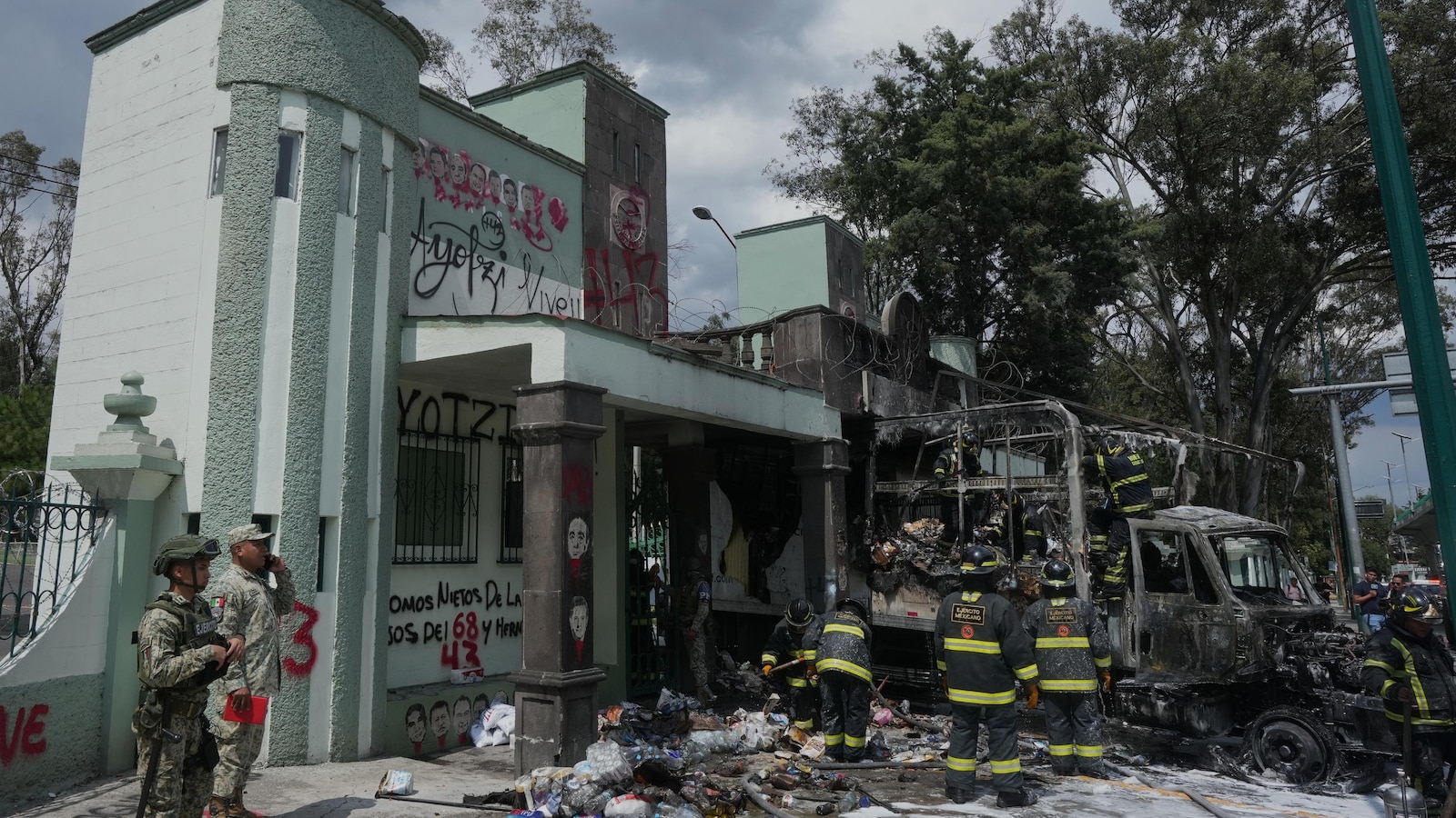 Protesters ram gates of Mexico City military base to demand answers in Ayotzinapa case