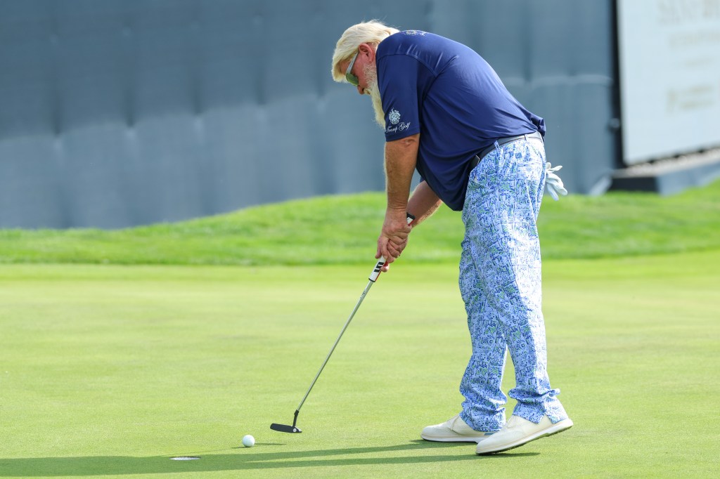 Daly putts on the 18th green during the first round