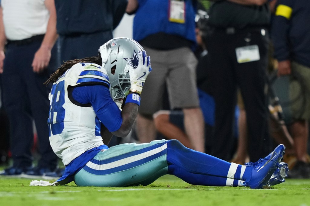 CeeDee Lamb grips his helmet after a missed catch