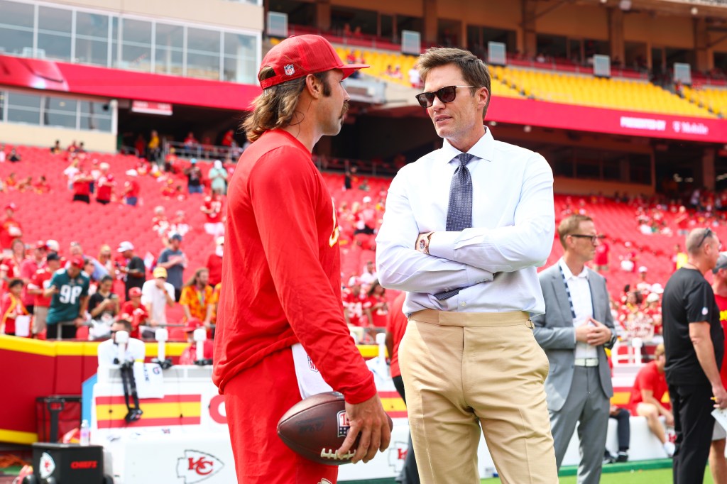Tom Brady speaking with a player before a broadcast