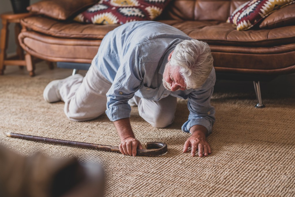 elder man lying on floor after a fall