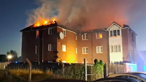 Three children hospitalised after fire at Enfield flat block