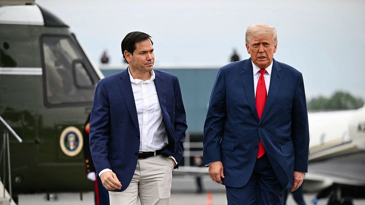 Rubio and Trump walk near a tarmac