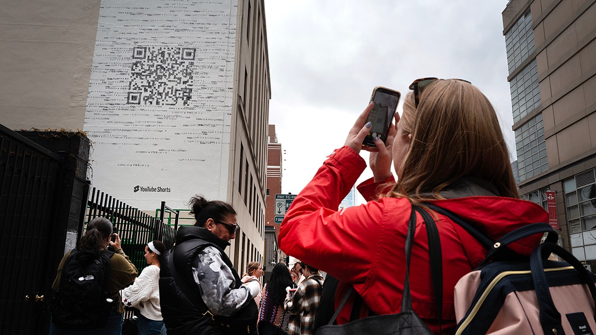 Person scanning a QR code on a phone