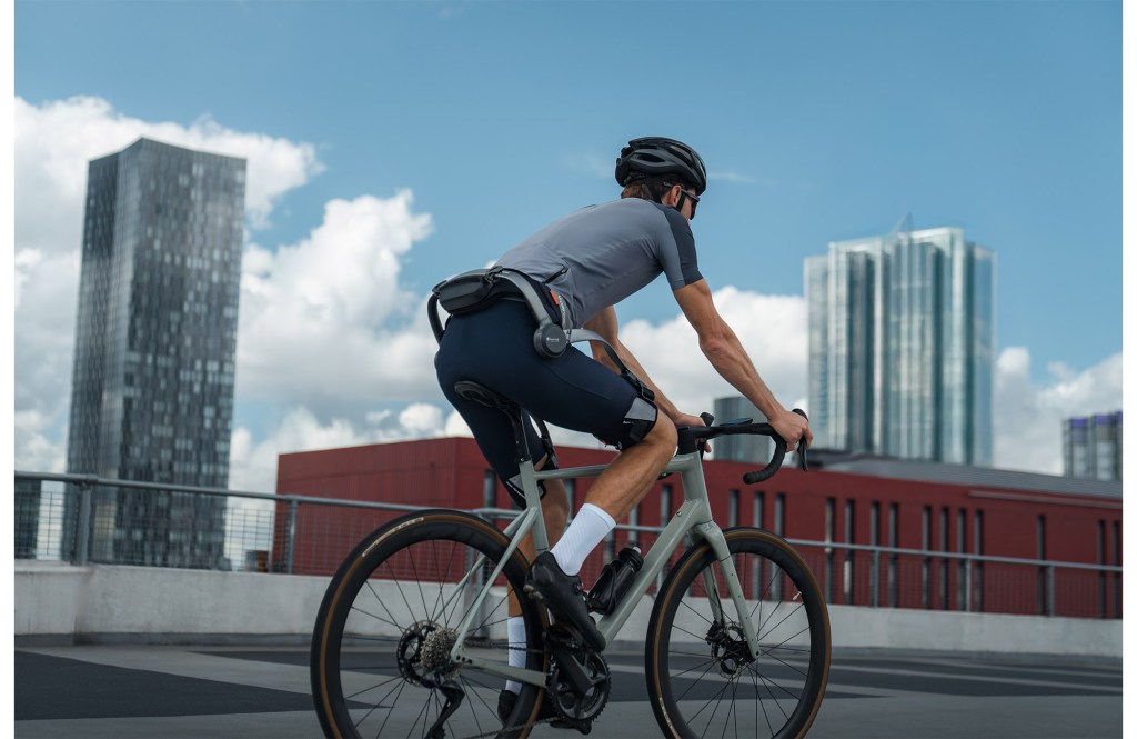 Cyclist wearing Hypershell exoskeleton on trail