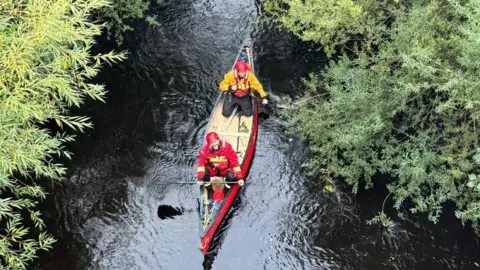 Volunteer search team near riverbank