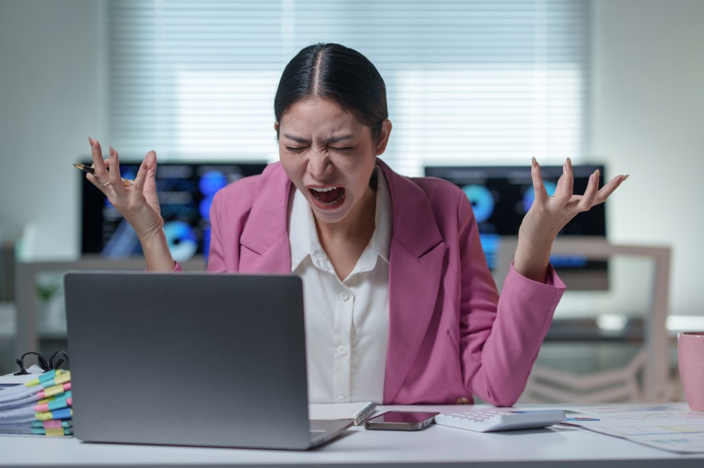 Young professional showing frustration at constant workplace demands